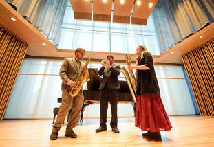 a trio perform on stage