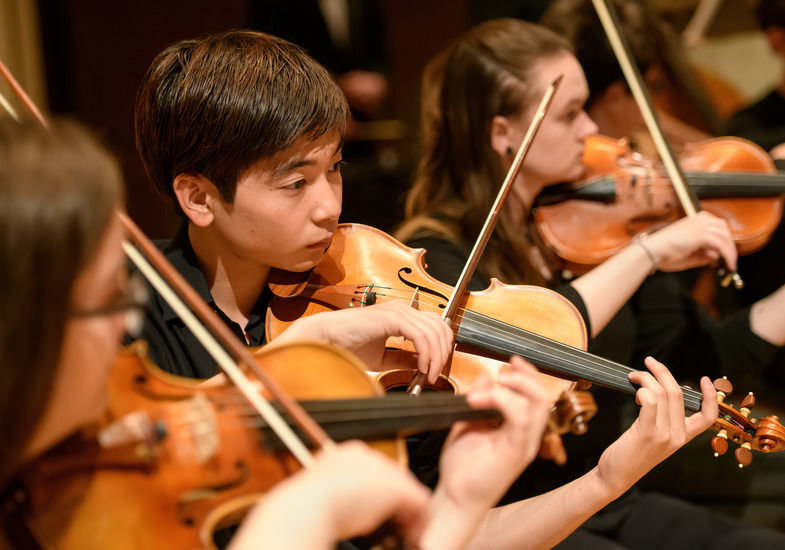 Violinists playing together during a concert