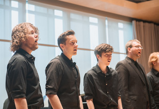 Group of men wearing all black singing in BCPA Recital Hall