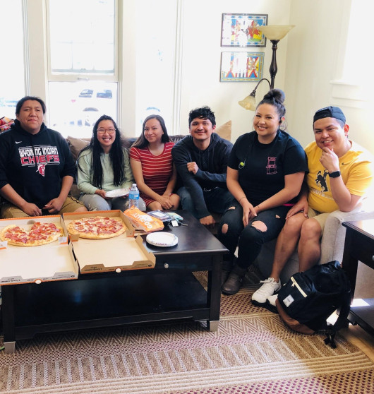 students gather to have pizza in native center