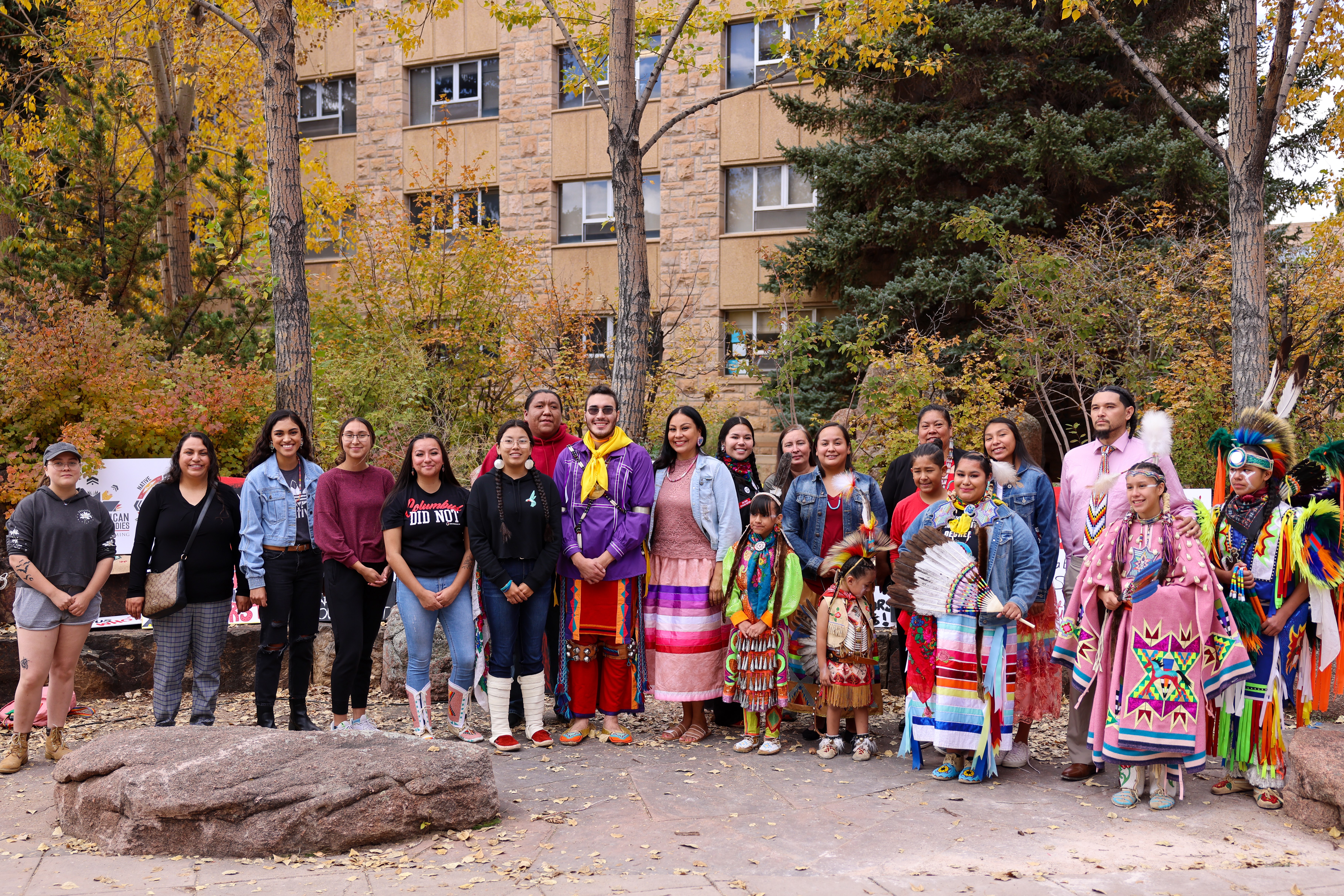 group of people outside of Native Center posing for homecoming parade