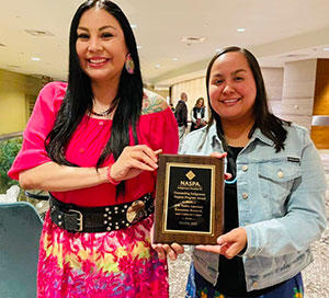 cass underwood and rainette curry accepting an award 