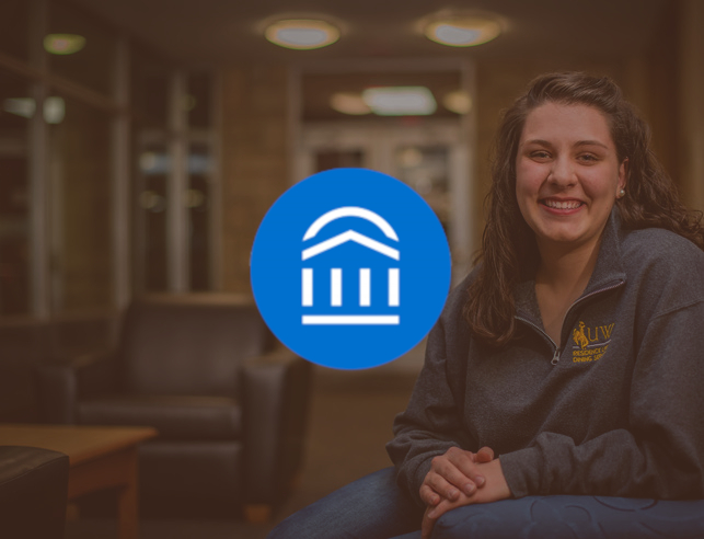 A student sitting in the lobby of the residence halls