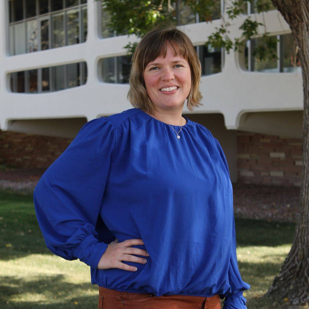 Dr. Sarah Kane stands in front of a building