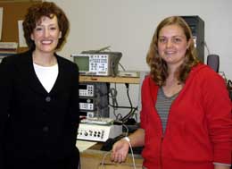 Two women standing by engineering computer