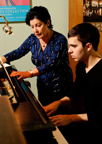Professor instructing piano student