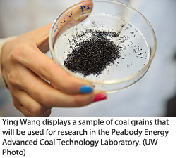 Ying Wang displays a sample of coal grains that will be used for research in the Peabody Energy Advanced Coal Technology Laboratory.