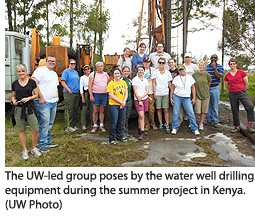 The UW-led group poses by the water well drilling equipment during the summer project in Kenya.