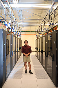 Man standing near computer servers