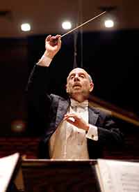 man in conducting orchestra