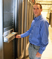 man standing in front of computer server