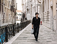 man walking down street of old city