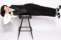 woman lying sideways across a stool