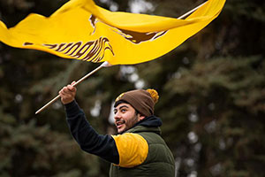 man waving a Universty of Wyoming flag