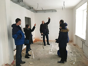 people in a room under construction