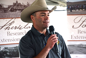 man in a cowboy hat holding a microphone