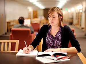 woman studying at a table