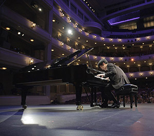man playing a concert piano