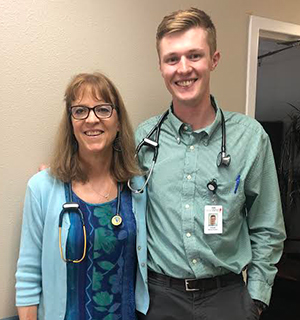 woman and man with stethoscopes standing beside each other