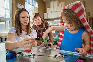 person helping small child with activity woman working with small child