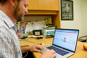 man looking at laptop computer