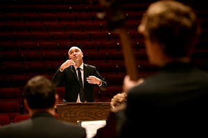 music conductor in front of musicians