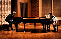 two people playing two pianos two people playing two pianos