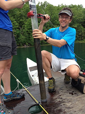 man on a boat using scientific equipment