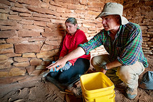 two people studying dig site