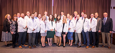 large group of people wearing white jackets