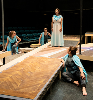 three students rehearsing a play