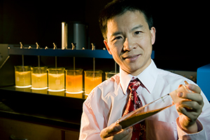 man holding a large tube with a sample in it