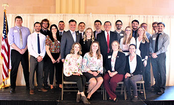 Large group of people in business attire posing for picture Large group of people posing for camera
