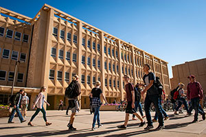 student walking near campus buildings