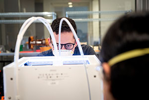 person in a mask working with equipment