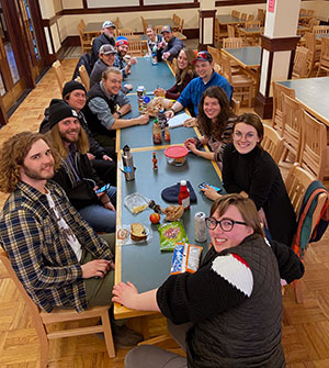 group of people seated at a long table