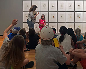 woman in front of a group of children