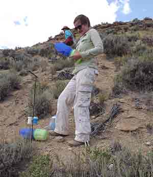 women with equipment on sagebrush-covered hillside