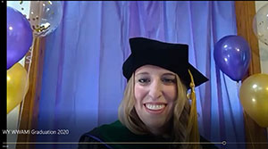 screen shot of woman in cap and gown