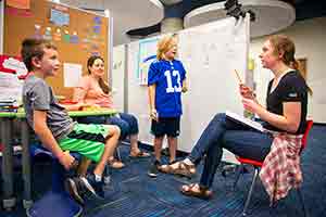 two woman and two children in a classroom