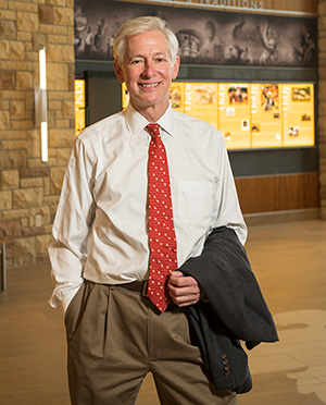 man standing with his suit jacket over his arm