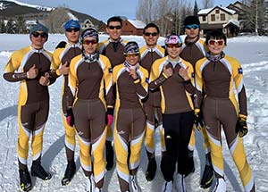 group of people with skiis in the snow