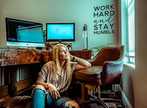 woman sitting on the floor by a desk