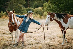 woman with two horses