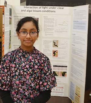 girl standing with poster