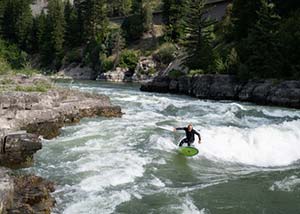 man surfing on whitewater river