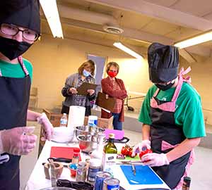 teenagers in masks preparing food