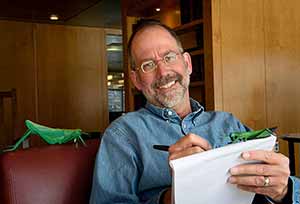 man with papers and toy locusts