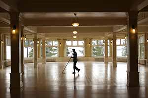 man sweeping empty room