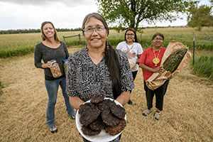 four women holding food